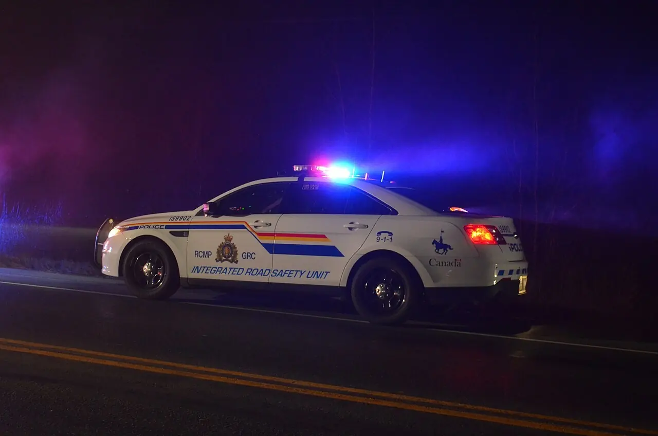RCMP traffic unit cruiser with emergency lights at night