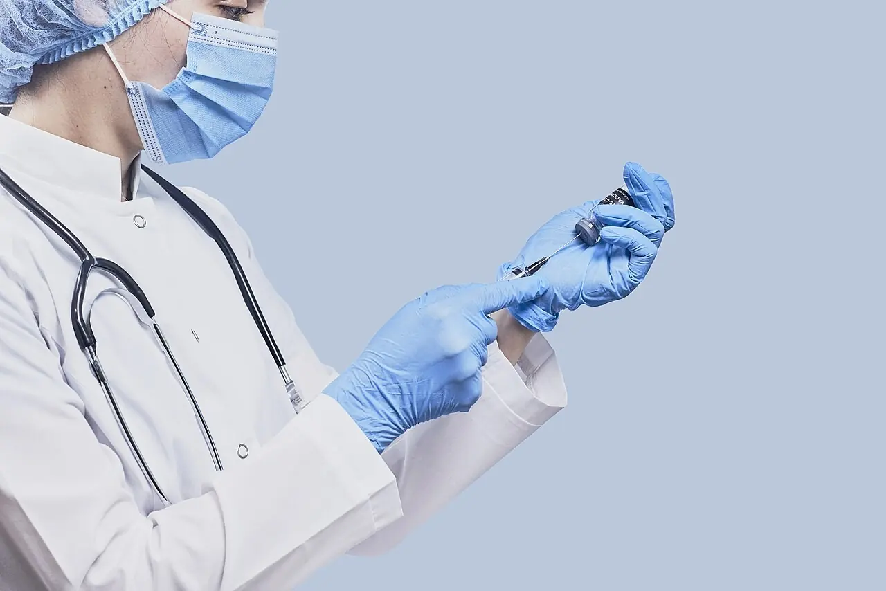 Doctor preparing a vaccine injection
