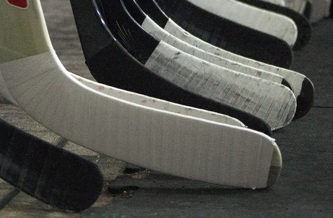 Taped blades of hockey sticks in a row