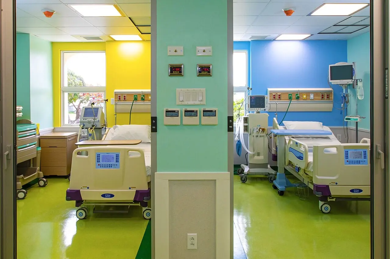 Brightly painted intensive care rooms with beds and monitors