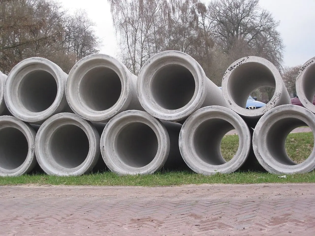 Stacked concrete sewer pipes at a work site
