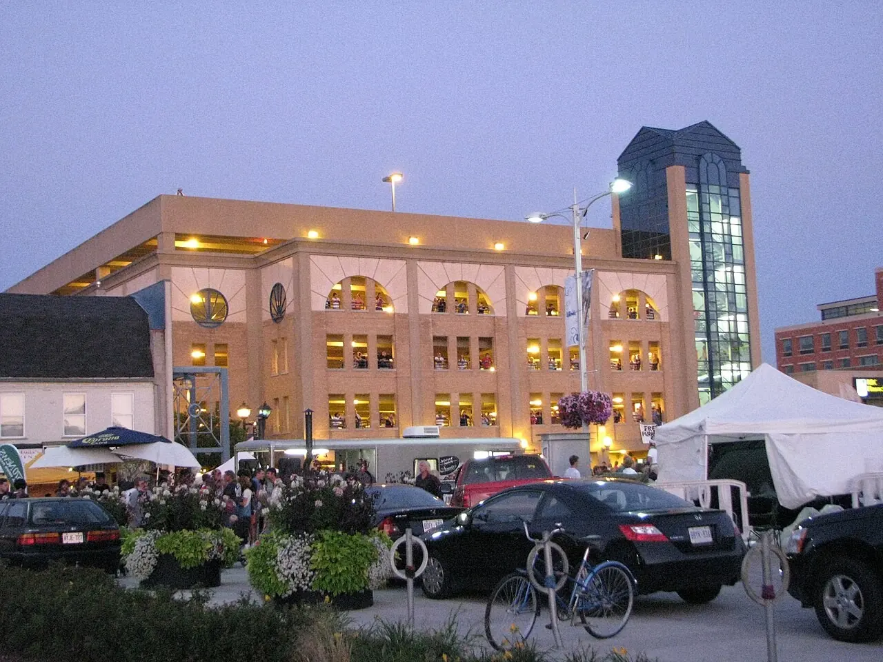 Uptown Waterloo building and parked cars at dusk