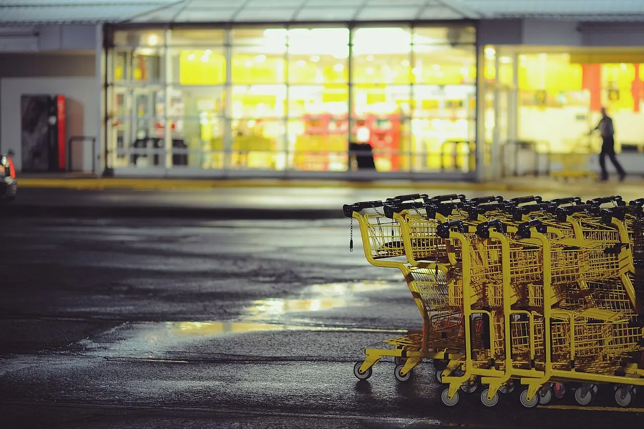 Shopping carts outside a lit store at night