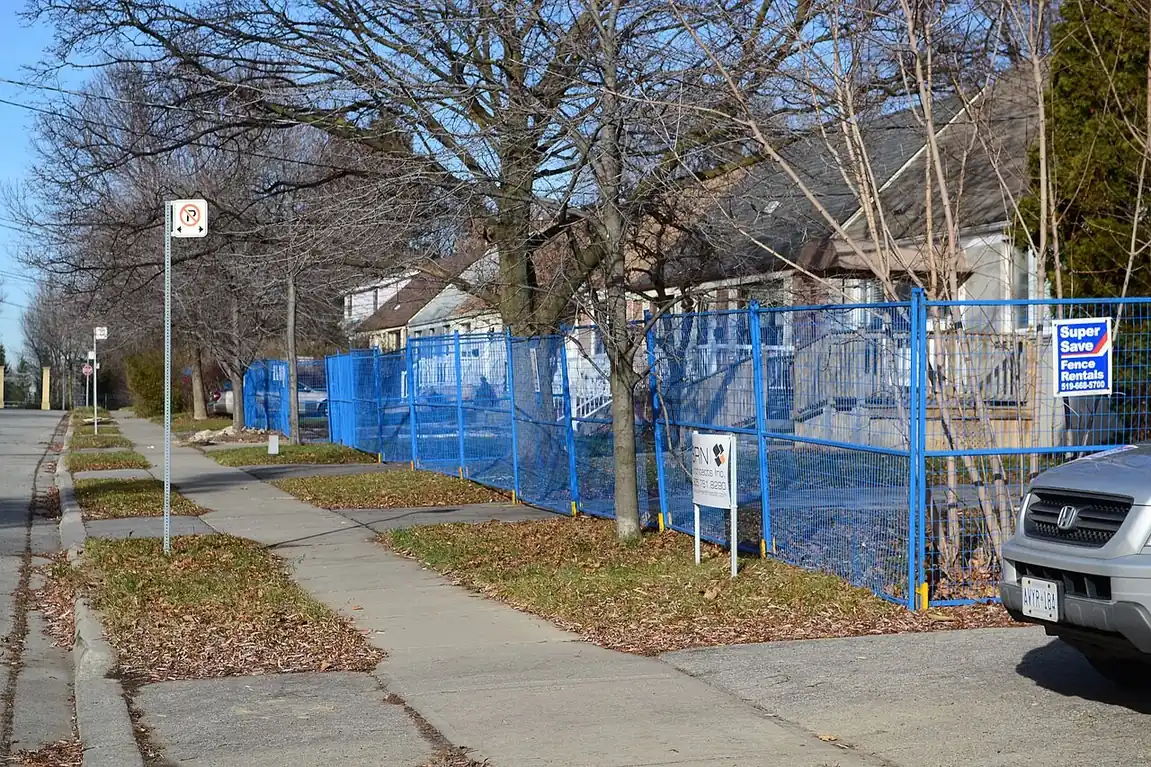 Row of fenced houses on a street slated for redevelopment