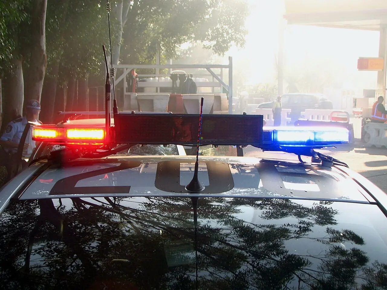 Red and blue emergency lights flashing on a police car
