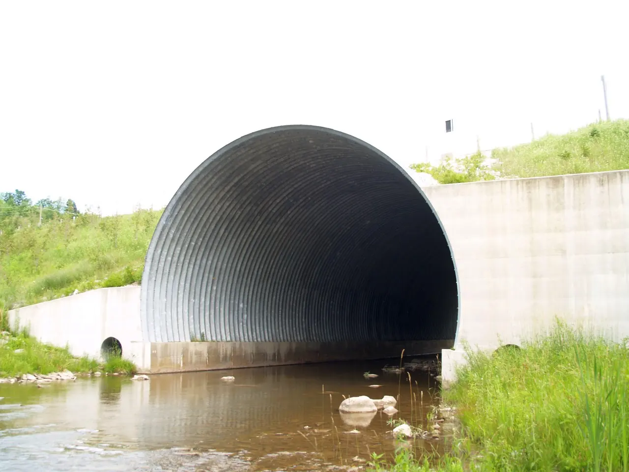 Corrugated steel culvert under a highway embankment