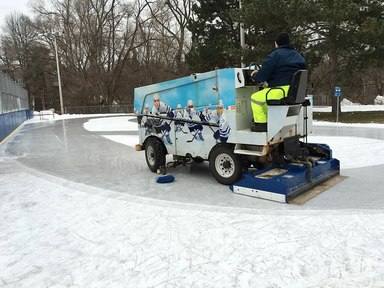 Ice resurfacer clearing an outdoor rink in winter