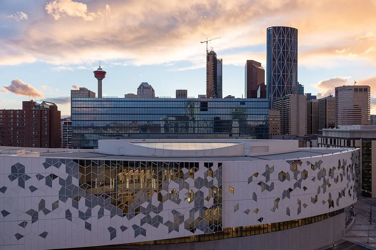 Calgary Central Library with downtown towers at sunset