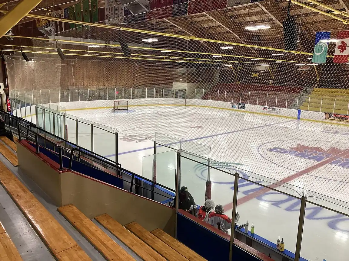 Hockey rink in a community arena with wooden bleachers