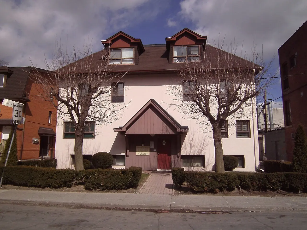 Pink stucco house on a street corner