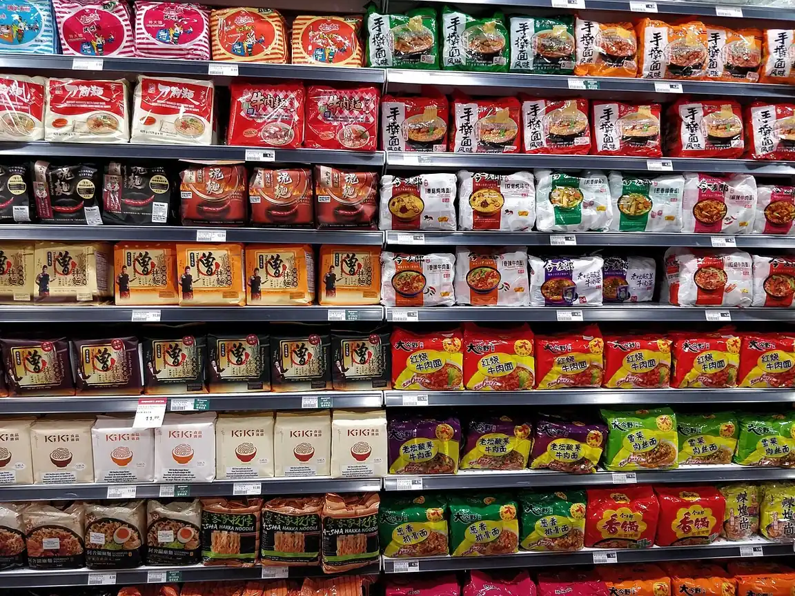 Shelves stocked with instant noodles in a supermarket