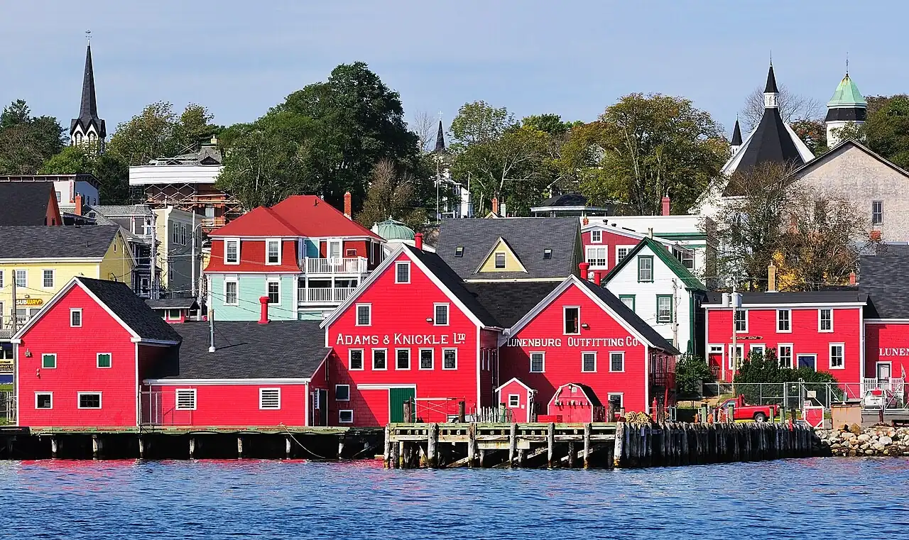 Red waterfront buildings and church spires in Lunenburg