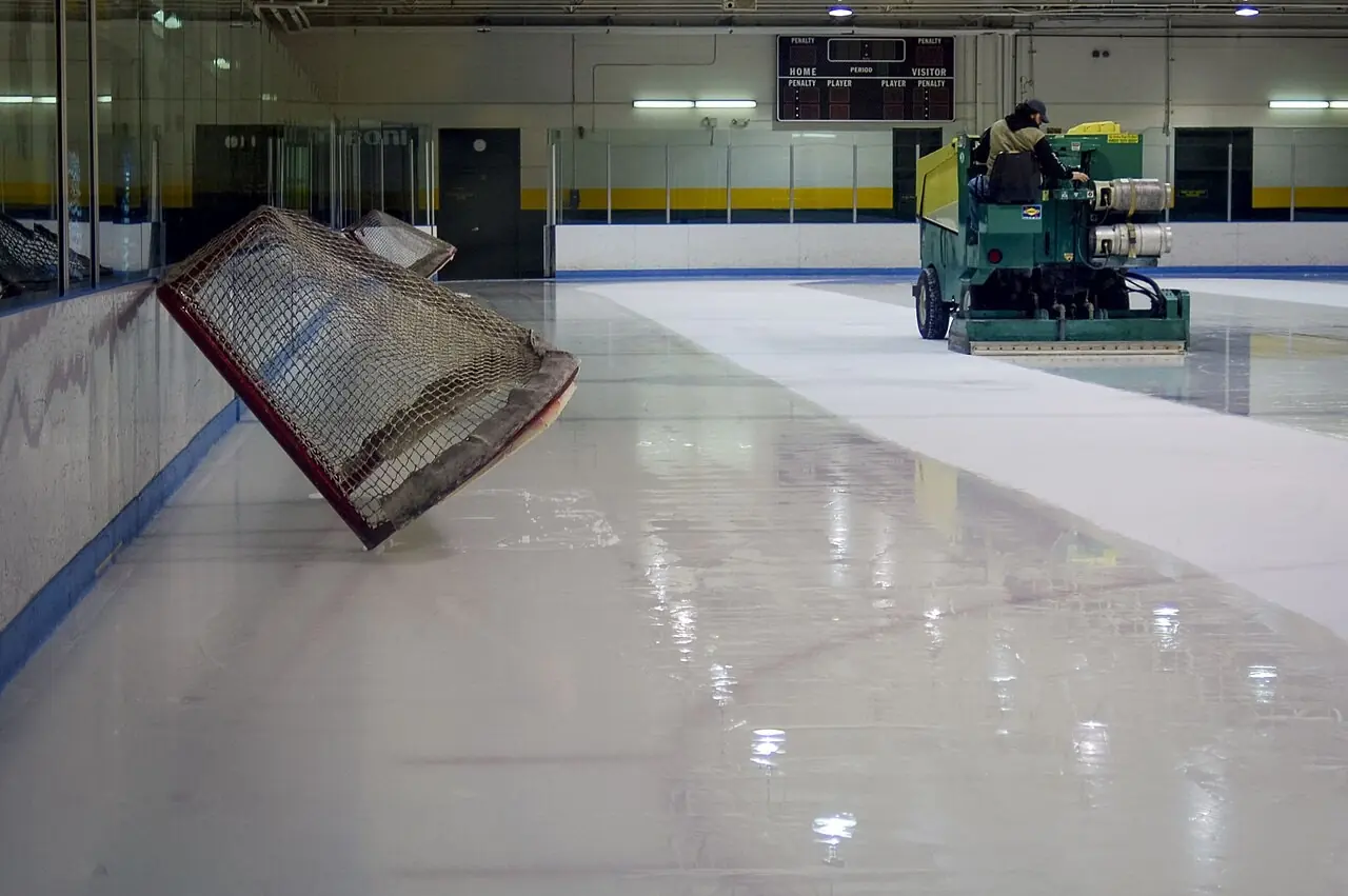 Hockey net tipped up as a resurfacer cleans the ice