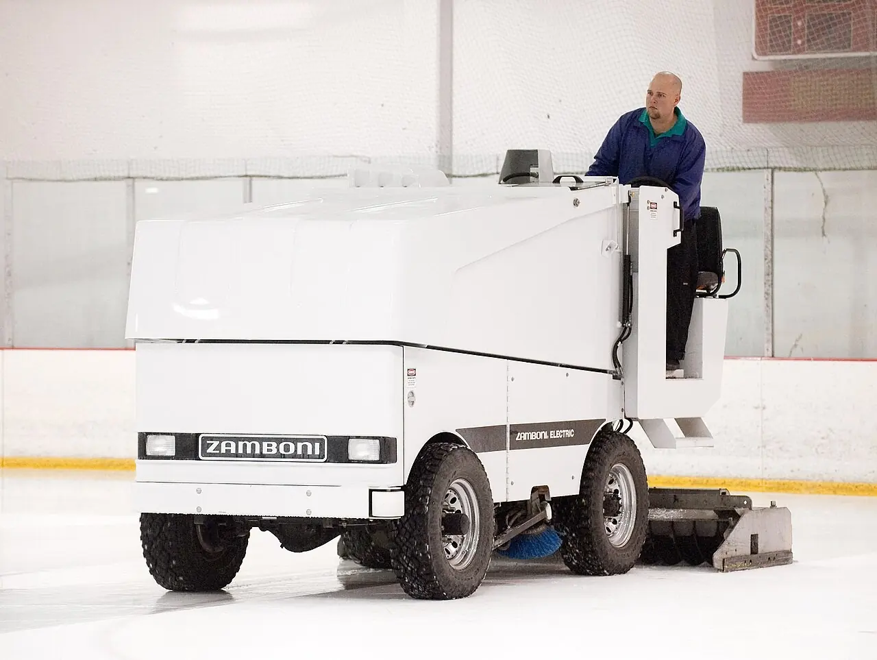 White ice resurfacer on a freshly cleaned rink
