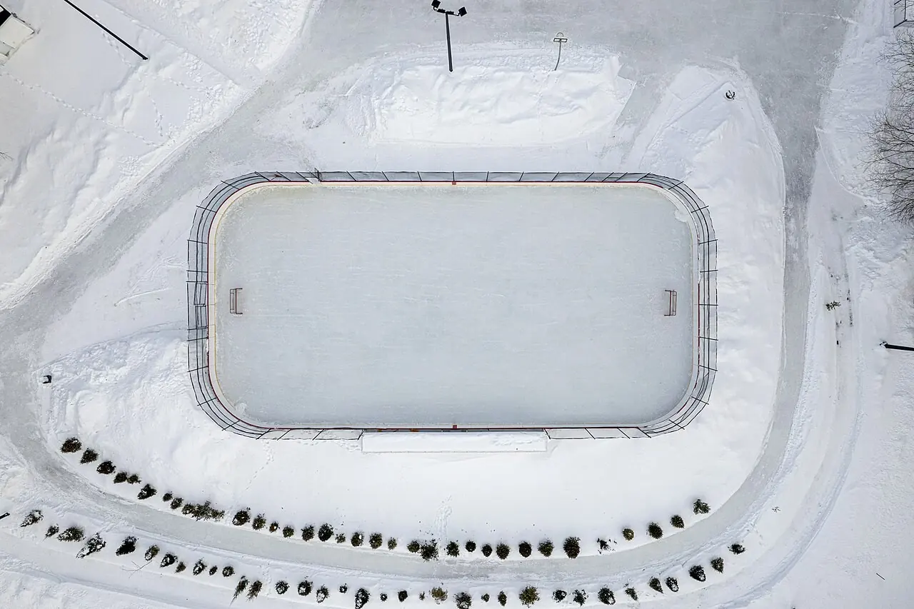 Aerial view of an outdoor hockey rink in the snow