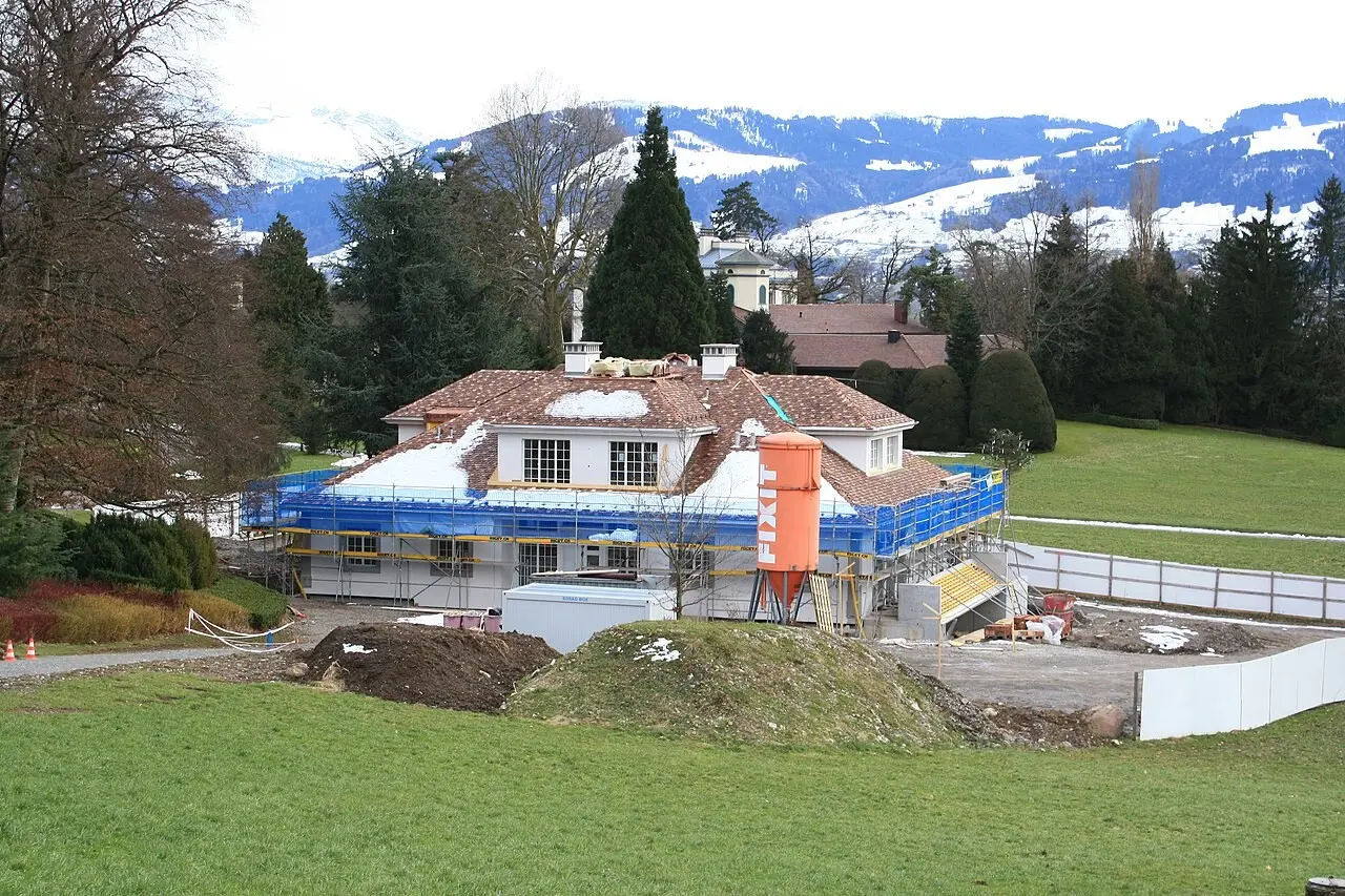 Building under construction with mountains in the background