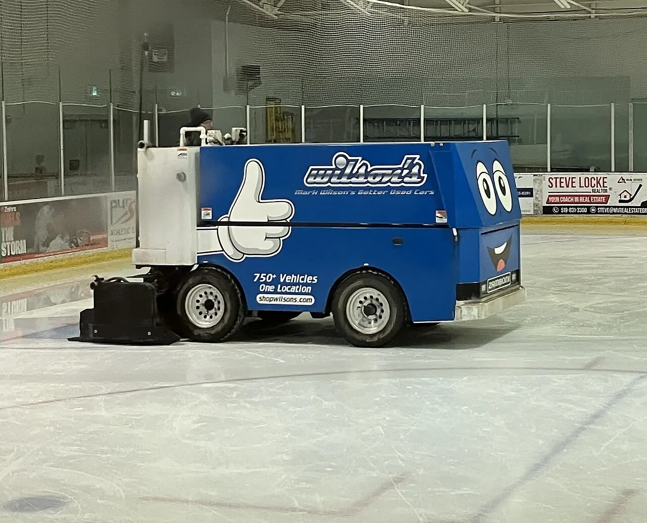 Blue ice resurfacer on a community arena rink
