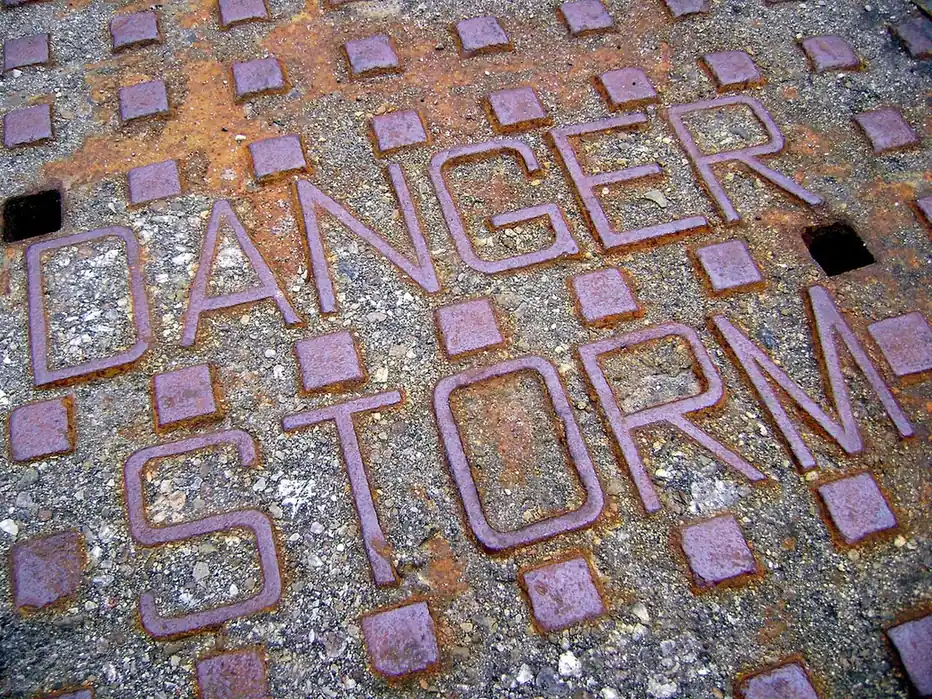 Storm sewer cover stamped Danger Storm