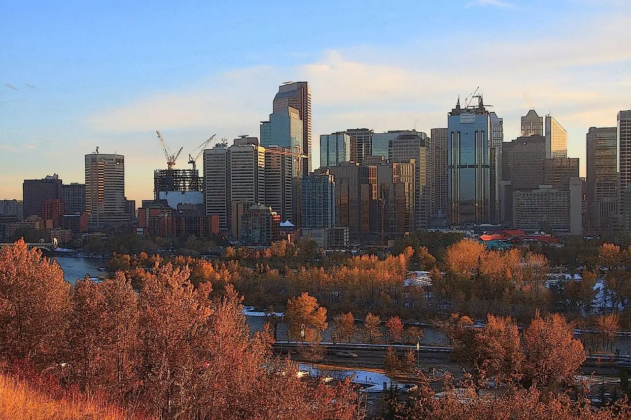 Downtown Calgary skyline above autumn trees along the Bow River